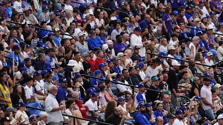 Jun 24, 2025; Denver, Colorado, USA; Los Angeles Dodgers and against the Colorado Rockies fans during the fourth inning at Coors Field. Mandatory Credit: Ron Chenoy-Imagn Images