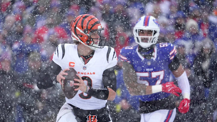 Cincinnati Bengals quarterback Joe Burrow runs away from Buffalo Bills defensive end AJ Epenesa and gets off a pass during first half action at Highmark Stadium in Orchard Park on Dec. 7, 2025.