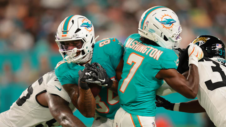 Miami Dolphins wide receiver Erik Ezukanma (84) runs with the football against Jacksonville Jaguars defensive end BJ Green II (95) during the second quarter at Hard Rock Stadium. Miami Dolphins wide receiver Erik Ezukanma (84) runs with the football against Jacksonville Jaguars defensive end BJ Green II (95) during the second quarter at Hard Rock Stadium.