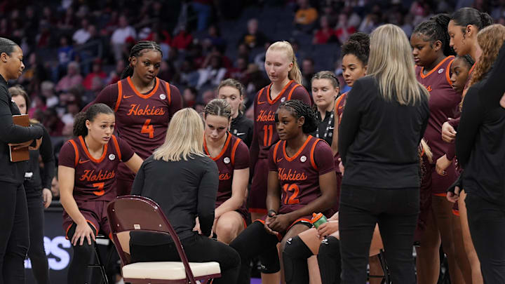 Nov 10, 2024; Charlotte, N.C.; Virginia Tech head coach Megan Duffy talks to her team during a time out against Iowa.