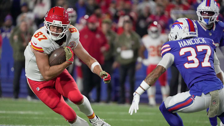 Kansas City Chiefs tight end Travis Kelce catches a pass and tries to avoid Buffalo Bills cornerback Jordan Hancock during first half action against the Kansas City Chiefs at Highmark Stadium in Orchard Park on Nov. 2, 2025.