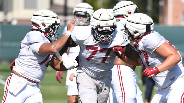 The Crimson Tide players and coaches continue working toward the season opener in practice Tuesday, Aug. 13, 2024. Alabama offensive lineman Parker Brailsford (72) and Alabama offensive lineman Jaeden Roberts (77) pull and block.