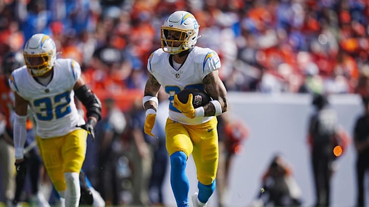 Oct 13, 2024; Denver, Colorado, USA; Los Angeles Chargers cornerback Elijah Molden (22) returns a interception in the first quarter against the Denver Broncos at Empower Field at Mile High. Mandatory Credit: Ron Chenoy-Imagn Images