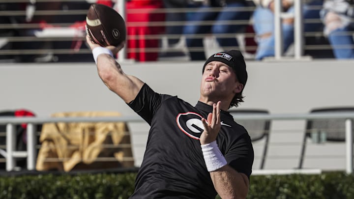 Nov 23, 2024; Athens, Georgia, USA; Georgia Bulldogs quarterback Ryan Puglisi (12) warms up on the field prior to the game against the Massachusetts Minutemen at Sanford Stadium. Mandatory Credit: Dale Zanine-Imagn Images