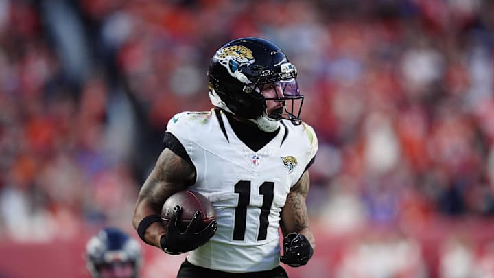 Dec 21, 2025; Denver, Colorado, USA; Jacksonville Jaguars wide receiver Parker Washington (11) makes a catch for a touchdown against the Denver Broncos during the second  half at Empower Field at Mile High. 