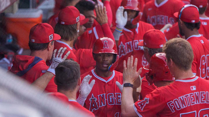 Feb 27, 2025; Mesa, Arizona, USA; Los Angeles Angels infielder Kyren Paris (19) celebrates with teammates after hitting a home run in the top of the ninth with two outs during a spring training game against the Chicago Cubs at Sloan Park to tie the game 4-4. Mandatory Credit: Allan Henry-Imagn Images