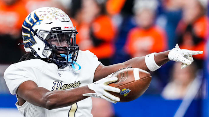 Decatur Central Hawks Kasmir Hicks (7) celebrates a touchdown Saturday, Nov. 30, 2024, during the Class 5A state final matchup between Warsaw Commmunity and Decatur Central at Lucas Oil Stadium in Indianapolis.