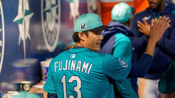 Seattle Mariners pitcher Shintaro Fujinami (13) celebrates with his team after pitching a scoreless seventh inning of a spring training game against the Los Angeles Dodgers at Peoria Sports Complex on March 7. 