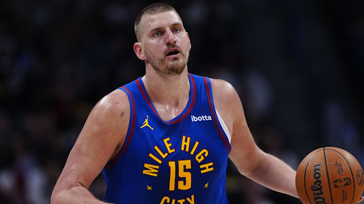 Mar 22, 2026; Denver, Colorado, USA; Denver Nuggets center Nikola Jokic (15) controls the ball in the first quarter against the Portland Trail Blazers at Ball Arena.