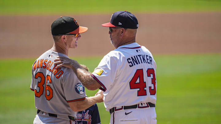 Jul 6, 2025; Cumberland, Georgia, USA; Baltimore Orioles interim manager Tony Mansolino (36) and Atlanta Braves manager Brian Snitker (43) meet on the field before the game at Truist Park. Mandatory Credit: Dale Zanine-Imagn Images