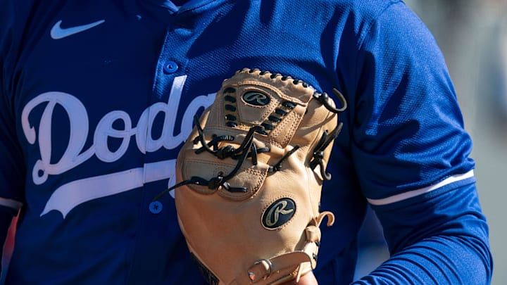 Feb 11, 2024; Glendale, AZ, USA; A general view of a glove and jersey belonging to a Los Angeles Dodgers pitcher Camelback Ranch during Spring Training Workouts. Mandatory Credit: Allan Henry-Imagn Images