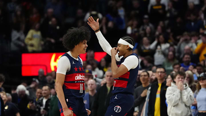 Mar 15, 2025; Denver, Colorado, USA; Washington Wizards guard Jordan Poole (13) celebrates his game winning three-point basket with forward Kyshawn George (18) in the fourth quarter against the Denver Nuggets at Ball Arena. Mandatory Credit: Ron Chenoy-Imagn Images