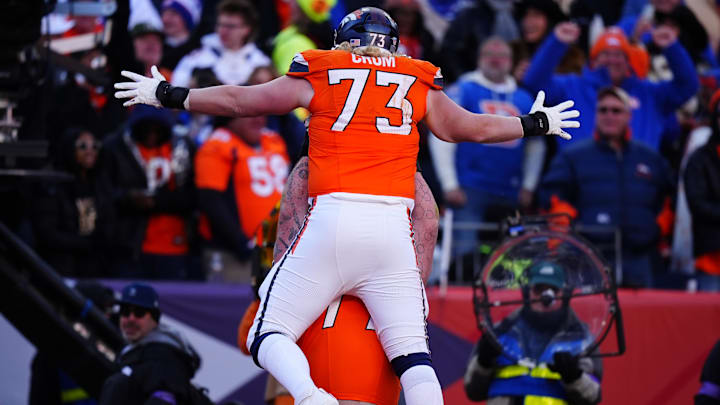 Jan 17, 2026; Denver, CO, USA; Denver Broncos offensive tackle Frank Crum (73) celebrates with teammates after a touchdown catch during the second quarter of an AFC Divisional Round playoff game against the Buffalo Bills at Empower Field at Mile High. 
