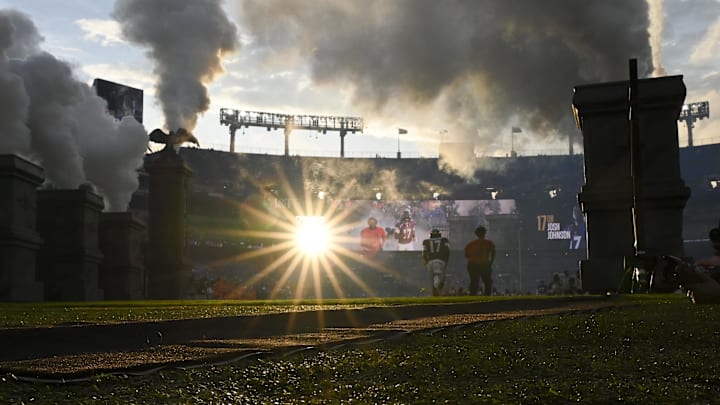 Aug 9, 2024; Baltimore, Maryland, USA; Baltimore Ravens quarterback Josh Johnson (17) runs onto the field with s spectator before a preseason game against the Philadelphia Eagles at M&T Bank Stadium. Mandatory Credit: Tommy Gilligan-Imagn Images