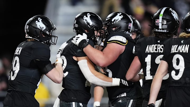 Oct 25, 2025; Laramie, Wyoming, USA; Wyoming Cowboys running back Sam Scott (22) celebrates his touchdown in the second half against the Colorado State Rams.