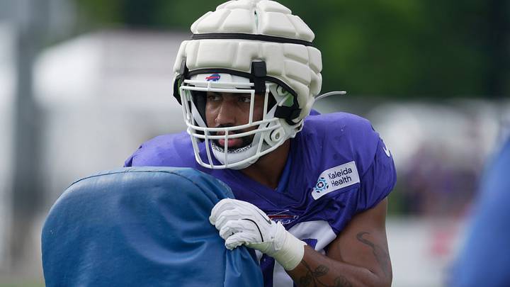 Bills Jackson Acker holds a pad to push against a teammate during a drill at Buffalo Bills Training Camp at St. John Fisher University in Pittsford on Aug. 6, 2026.