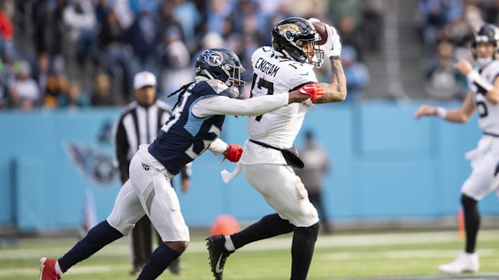 Jan 7, 2024; Nashville, Tennessee, USA;  Jacksonville Jaguars tight end Evan Engram (17) makes a catch as Tennessee Titans safety Terrell Edmunds (38) defends during the second half at Nissan Stadium. Mandatory Credit: Steve Roberts-Imagn Images