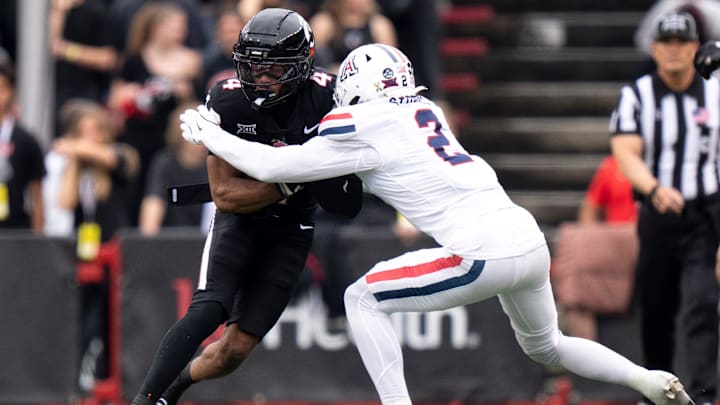 Arizona Wildcats defensive back Treydan Stukes (2) tackles Cincinnati Bearcats wide receiver Cyrus Allen (4) in the second quarter of the NCAA football at Nippert Stadium in Cincinnati on Nov. 15, 2025. Arizona Wildcats defensive back Treydan Stukes (2) tackles Cincinnati Bearcats wide receiver Cyrus Allen (4) in the second quarter of the NCAA football at Nippert Stadium in Cincinnati on Nov. 15, 2025.