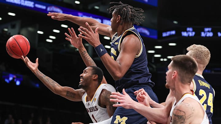 Nov 17, 2022; Brooklyn, New York, USA; Arizona State Sun Devils guard Luther Muhammad (1) drives to the basket as Michigan Wolverines forward Tarris Reed Jr. (32) defends during the second half at Barclays Center. Mandatory Credit: Vincent Carchietta-Imagn Images