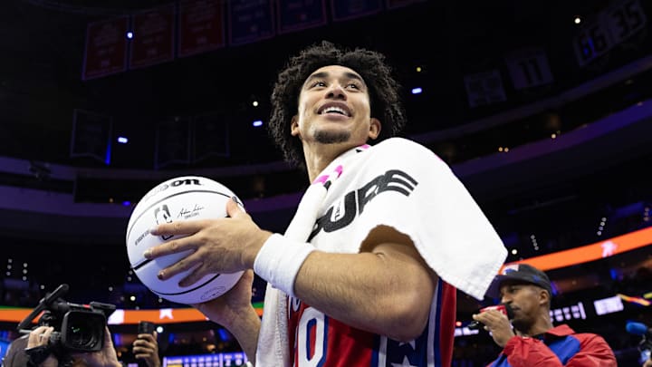 Nov 22, 2024; Philadelphia, Pennsylvania, USA; Philadelphia 76ers guard Jared McCain (20) prepares to throw a game ball to fans after a victory against the Brooklyn Nets at Wells Fargo Center. Mandatory Credit: Bill Streicher-Imagn Images
