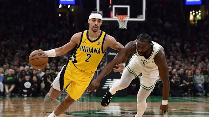 Dec 29, 2024; Boston, Massachusetts, USA; Indiana Pacers guard Andrew Nembhard (2) controls the ball while Boston Celtics guard Jaylen Brown (7) defends during the second half at TD Garden. Mandatory Credit: Bob DeChiara-Imagn Images