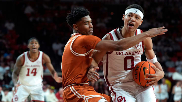 Oklahoma Sooners guard Jeremiah Fears (0) is fouled by Texas Longhorns guard Julian Larry (1) during an SEC men's college basketball game between the University of Oklahoma Sooners (OU) and the Texas Longhorns at Lloyd Noble Center in Norman, Okla., Wednesday, Jan. 15, 2025. Texas won 77-73.