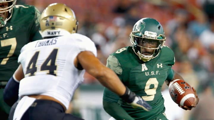 Quinton Flowers (9) ran for 176 yards and two touchdowns and threw for two more TDs when USF upset 22nd-ranked Navy in 2016. It was the Bulls' last win against a ranked team.