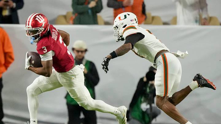 Miami (FL) Hurricanes safety Zechariah Poyser (7) chases after Indiana Hoosiers wide receiver Omar Cooper Jr. (3) as he rushes the ball Monday, Jan. 19, 2026, during the College Football Playoff National Championship college football game at Hard Rock Stadium in Miami Gardens.
