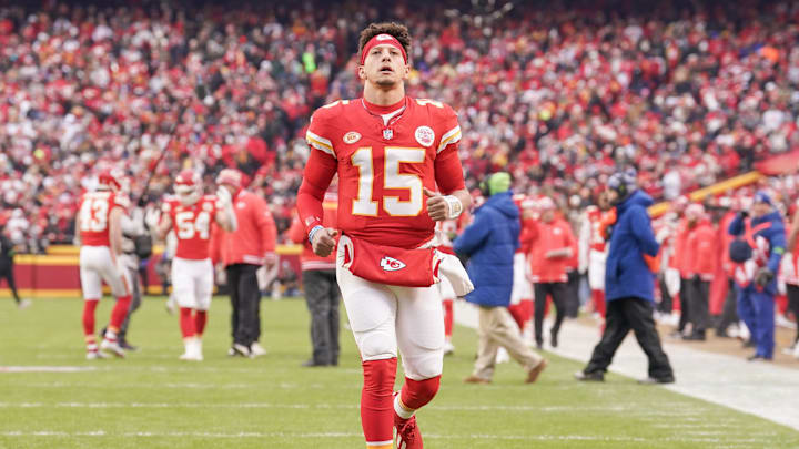Dec 31, 2023; Kansas City, Missouri, USA; Kansas City Chiefs quarterback Patrick Mahomes (15) runs to celebrate toward fans on field against the Cincinnati Bengals prior to a game at GEHA Field at Arrowhead Stadium. Mandatory Credit: Denny Medley-Imagn Images