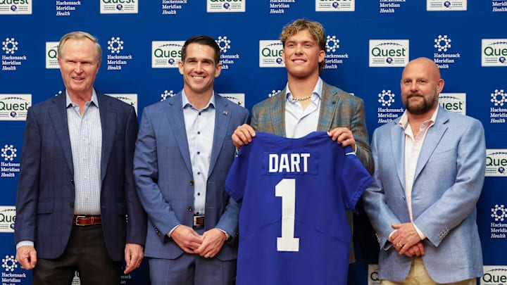 Apr 25, 2025; East Rutherford, NJ, US; New York Giants president John Mara (far left), general manager Joe Schoen (left), Jaxson Dart, and head coach Brian Daboll (right) pose for photos prior to the start of the press conference to introduce the Giants first round draft picks. Apr 25, 2025; East Rutherford, NJ, US; New York Giants president John Mara (far left), general manager Joe Schoen (left), Jaxson Dart, and head coach Brian Daboll (right) pose for photos prior to the start of the press conference to introduce the Giants first round draft picks.