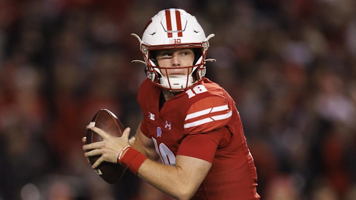 Oct 28, 2023; Madison, Wisconsin, USA;  Wisconsin Badgers quarterback Braedyn Locke (18) scrambles with the football during the second quarter against the Ohio State Buckeyes at Camp Randall Stadium. Mandatory Credit: Jeff Hanisch-Imagn Images