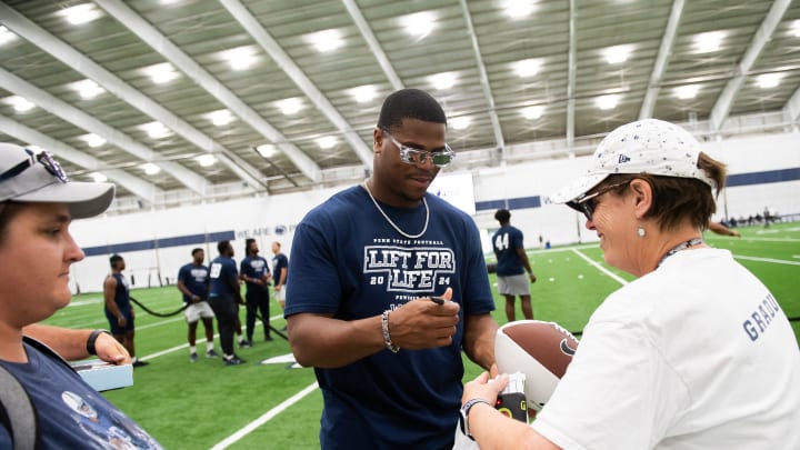 Penn State defensive end Abdul Carter signs autographs for fans during the 21st annual Lift for Life in Holuba Hall. 