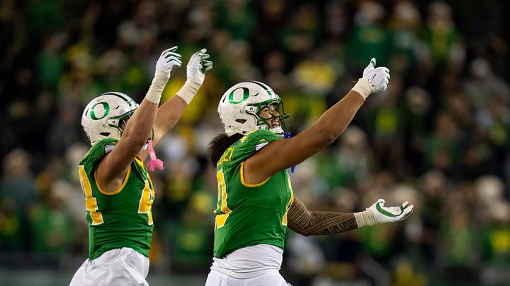 Oregon outside linebackers Matayo Uiagalelei, right, and Teitum Tuioti take the field as the Oregon Ducks host the Minnesota Golden Gophers on Nov. 14, 2025, at Autzen Stadium in Eugene, Oregon.