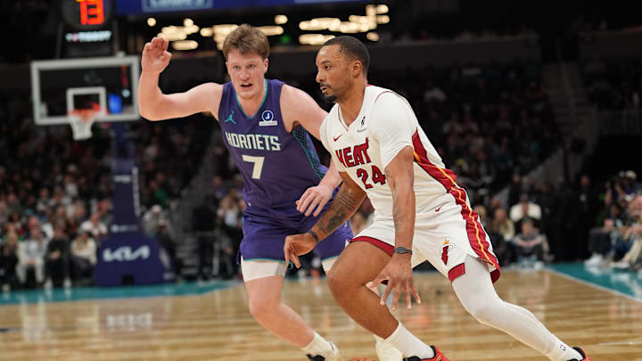 Mar 17, 2026; Charlotte, North Carolina, USA; Miami Heat guard Norman Powell (24) moves the ball against Charlotte Hornets guard Kon Knueppel (7) during the second half at Spectrum Center. Mandatory Credit: Jim Dedmon-Imagn Images