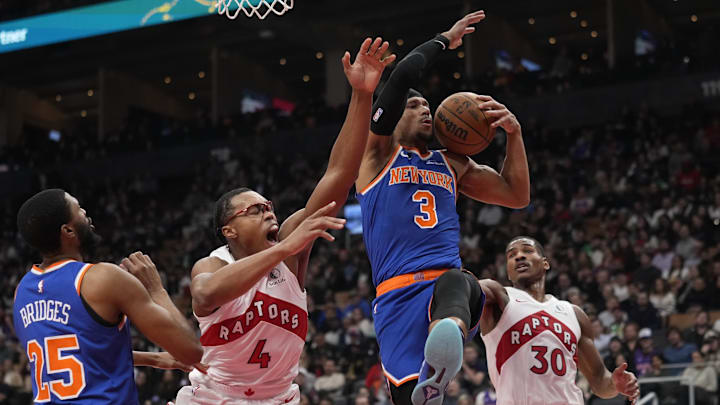 Dec 9, 2024; Toronto, Ontario, CAN; Toronto Raptors forward Scottie Barnes (4) and New York Knicks guard Josh Hart (3) battle for a rebound during the first half at Scotiabank Arena. Mandatory Credit: John E. Sokolowski-Imagn Images