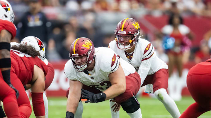 Sep 29, 2024; Glendale, Arizona, USA; Washington Commanders center Tyler Biadasz (63) prepares to snap the ball to quarterback Jayden Daniels (5) against the Arizona Cardinals at State Farm Stadium. Mandatory Credit: Mark J. Rebilas-Imagn Images
