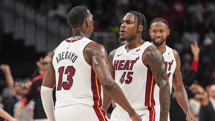 Apr 18, 2025; Atlanta, Georgia, USA; Miami Heat guard Davion Mitchell (45) reacts with center Bam Adebayo (13) after the Heat defeated the Atlanta Hawks in overtime at State Farm Arena. Mandatory Credit: Dale Zanine-Imagn Images