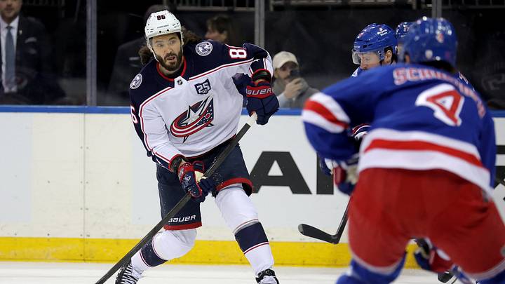 Mar 2, 2026; New York, New York, USA; Columbus Blue Jackets right wing Kirill Marchenko (86) takes a shot against New York Rangers left wing J.T. Miller (8) and defenseman Braden Schneider (4) during the first period at Madison Square Garden. Mandatory Credit: Brad Penner-Imagn Images