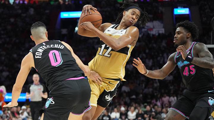 Apr 4, 2026; Miami, Florida, USA; Washington Wizards guard Tre Johnson (12) splits the defense of Miami Heat forward Simone Fontecchio (0) and guard Davion Mitchell (45) during the second half at Kaseya Center. Mandatory Credit: Jim Rassol-Imagn Images Apr 4, 2026; Miami, Florida, USA; Washington Wizards guard Tre Johnson (12) splits the defense of Miami Heat forward Simone Fontecchio (0) and guard Davion Mitchell (45) during the second half at Kaseya Center. Mandatory Credit: Jim Rassol-Imagn Images