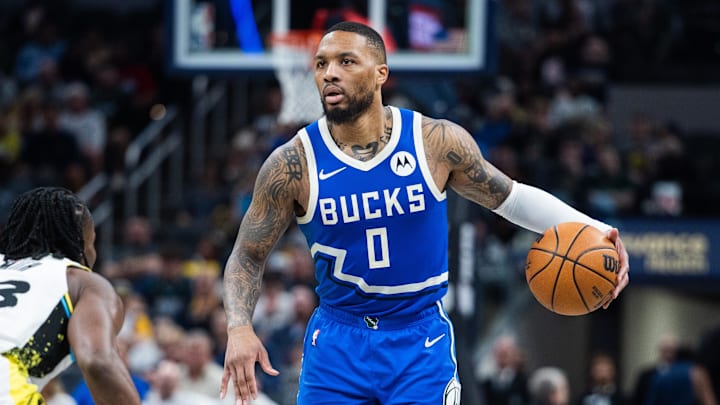 Mar 11, 2025; Indianapolis, Indiana, USA; Milwaukee Bucks guard Damian Lillard (0) dribbles the ball while Indiana Pacers forward Aaron Nesmith (23) defends in the second half  at Gainbridge Fieldhouse. Mandatory Credit: Trevor Ruszkowski-Imagn Images