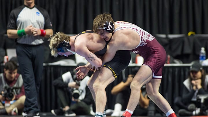 Mar 18, 2023; Tulsa, OK, USA; Iowa wrestler Max Murin (left) wrestles Virginia Tech wrestler Caleb Henson in the 149 pound weight class fifth place match during the NCAA Wrestling Championships at the BOK Center. Mandatory Credit: Brett Rojo-Imagn Images