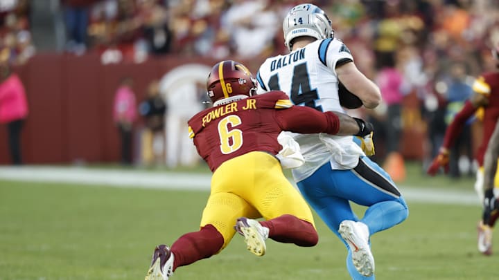 Oct 20, 2024; Landover, Maryland, USA; Carolina Panthers quarterback Andy Dalton (14). Is tackled by Washington Commanders linebacker Dante Fowler Jr. (6) during the fourth quarter at Northwest Stadium. Mandatory Credit: Geoff Burke-Imagn Images