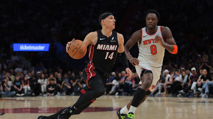 Mar 2, 2025; Miami, Florida, USA; Miami Heat guard Tyler Herro (14) drives to the basket past New York Knicks forward OG Anunoby (8) during the fourth quarter at Kaseya Center. Mandatory Credit: Sam Navarro-Imagn Images