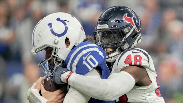 Houston Texans linebacker Christian Harris (48) brings down Indianapolis Colts quarterback Gardner Minshew II (10) on Saturday, Jan. 6, 2024, during a game against the Houston Texans at Lucas Oil Stadium in Indianapolis.