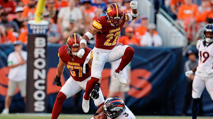 Sep 17, 2023; Denver, Colorado, USA; Denver Broncos quarterback Russell Wilson (3) slides for a first down against Washington Commanders safety Darrick Forrest (22) Sep 17, 2023; Denver, Colorado, USA; Denver Broncos quarterback Russell Wilson (3) slides for a first down against Washington Commanders safety Darrick Forrest (22)