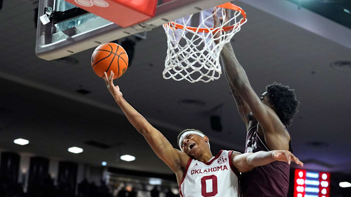 Oklahoma Sooners guard Jeremiah Fears (0) is fouled by Texas A&M Aggies forward Solomon Washington (9) during an SEC men's college basketball game between the University of Oklahoma Sooners (OU) and the Texas A&M Aggies at Lloyd Noble Center in Norman, Okla., Wednesday, Jan. 8, 2025. Texas A&M won 80-78.