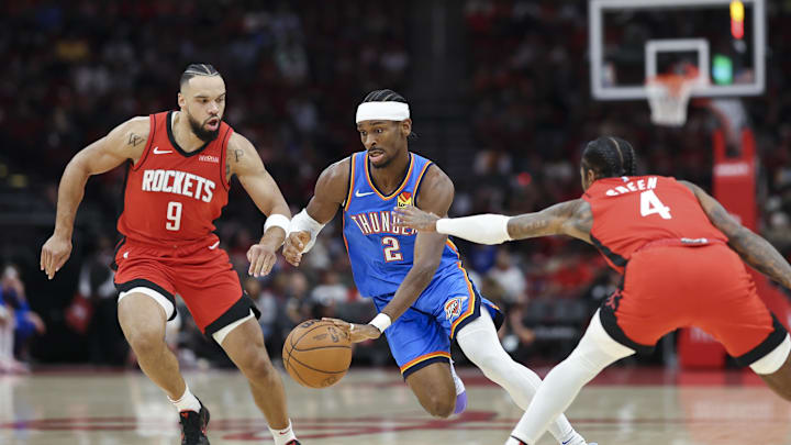 Dec 1, 2024; Houston, Texas, USA; Oklahoma City Thunder guard Shai Gilgeous-Alexander (2) drives with the ball as Houston Rockets forward Dillon Brooks (9) and guard Jalen Green (4) defend during the first quarter at Toyota Center. Mandatory Credit: Troy Taormina-Imagn Images Dec 1, 2024; Houston, Texas, USA; Oklahoma City Thunder guard Shai Gilgeous-Alexander (2) drives with the ball as Houston Rockets forward Dillon Brooks (9) and guard Jalen Green (4) defend during the first quarter at Toyota Center. Mandatory Credit: Troy Taormina-Imagn Images