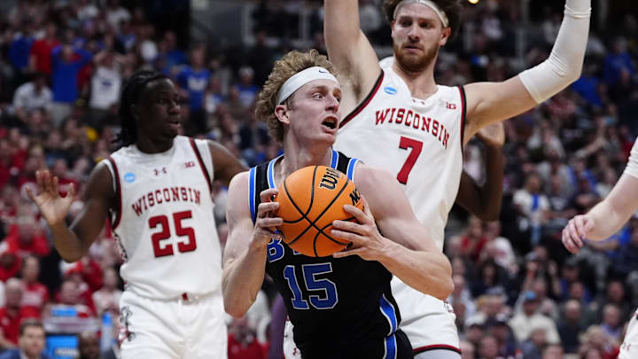 Mar 22, 2025; Denver, CO, USA; Brigham Young Cougars forward Richie Saunders (15) grabs a rebound against the Wisconsin Badgers during the first half in the first round of the NCAA Tournament  at Ball Arena. Mandatory Credit: Ron Chenoy-Imagn Images