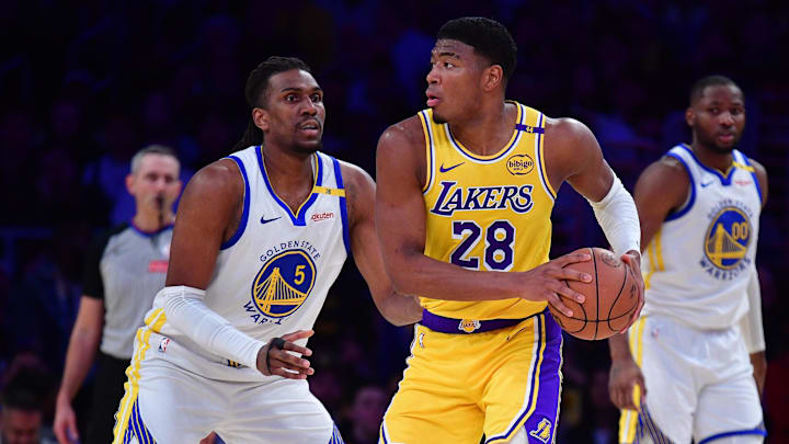 Apr 3, 2025; Los Angeles, California, USA; Los Angeles Lakers forward Rui Hachimura (28) controls the ball against Golden State Warriors forward Kevon Looney (5) during the second half at Crypto.com Arena. Mandatory Credit: Gary A. Vasquez-Imagn Images