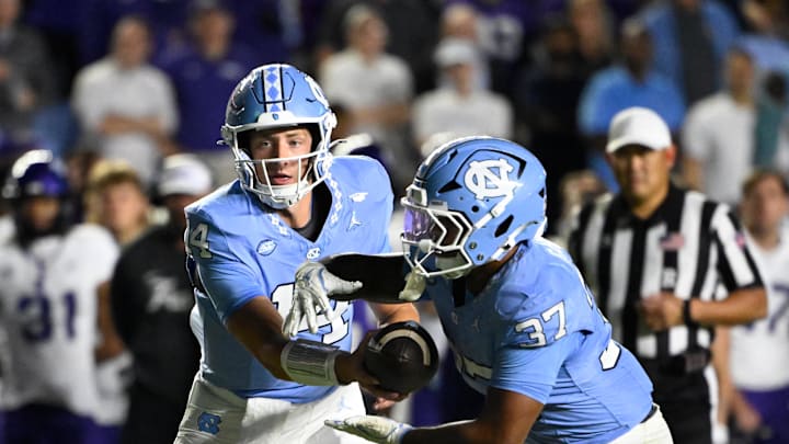 Sep 1, 2025; Chapel Hill, North Carolina, USA; North Carolina Tar Heels quarterback Max Johnson (14) hands the ball off to Drunning back Davion Gause (37) in the third quarter at Kenan Stadium. Mandatory Credit: Bob Donnan-Imagn Images